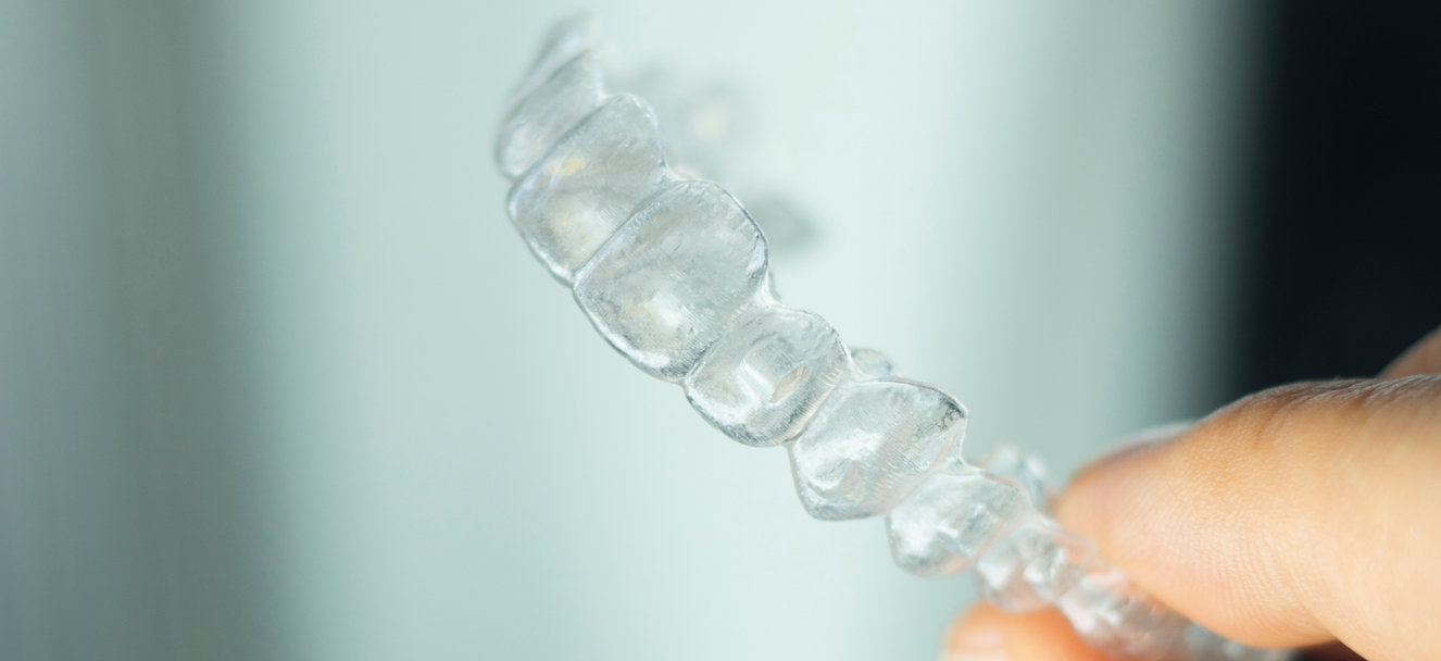 Hands holding dental models
